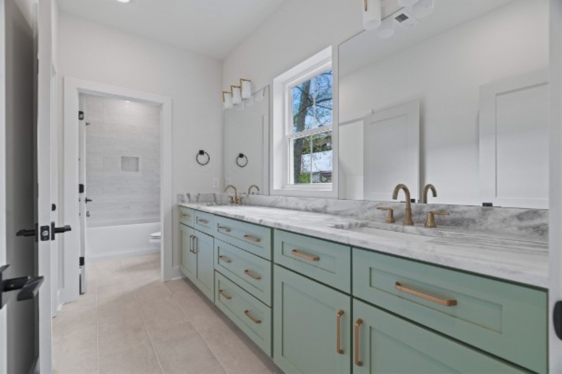 603 Morrow Road, Unit A Nashville, TN 37209 - Photo 29 of 38 a bathroom with double sink and a mirror