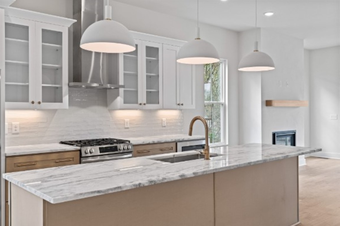 603 Morrow Road, Unit A Nashville, TN 37209 - Photo 6 of 38 a kitchen with stainless steel appliances granite countertop a sink a stove and a wooden cabinets