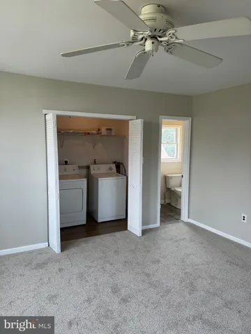 a view of a utility room with a sink and cabinets