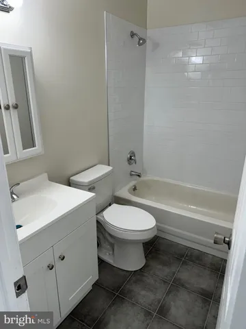 a bathroom with a toilet sink and shower