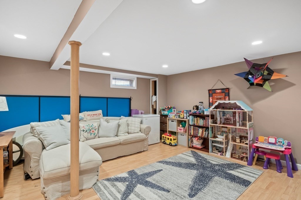 93 Palmer Road Plymouth, MA 02360 - Photo 18 of 34 a living room with furniture a wooden floor and a chandelier