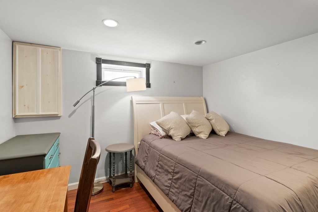 93 Palmer Road Plymouth, MA 02360 - Photo 20 of 34 a bedroom with a bed and wooden floor