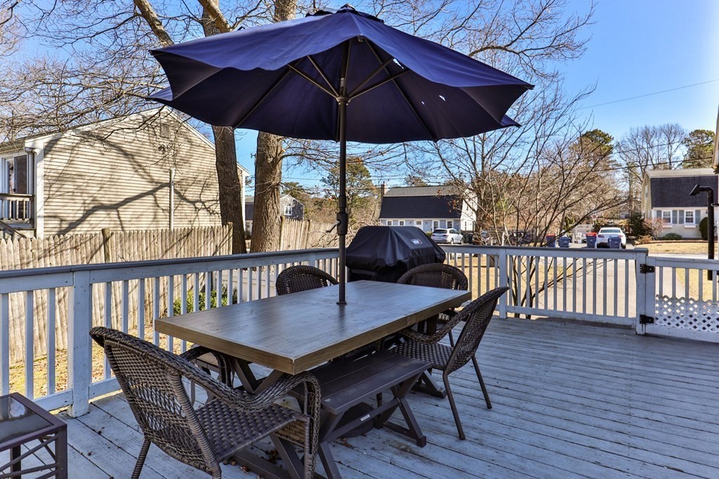 93 Palmer Road Plymouth, MA 02360 - Photo 21 of 34 a patio with wooden floor a yard a table and chairs