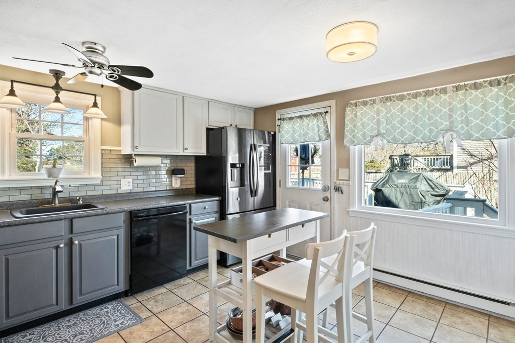 93 Palmer Road Plymouth, MA 02360 - Photo 7 of 34 a kitchen with granite countertop stainless steel appliances a table and chairs in it