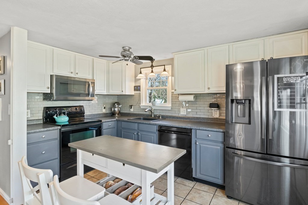 93 Palmer Road Plymouth, MA 02360 - Photo 8 of 34 a kitchen with stainless steel appliances granite countertop a refrigerator a stove a sink a dining table and chairs