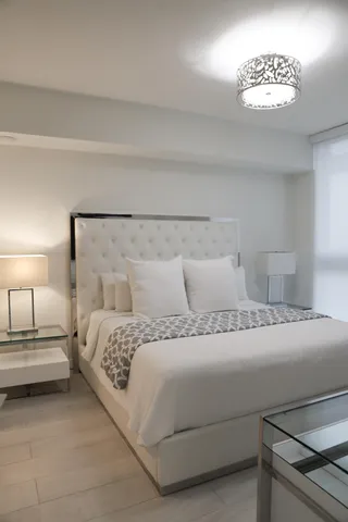 a bedroom with a bed and a lamp