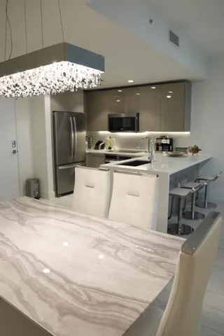 a kitchen with a sink a stove and chairs