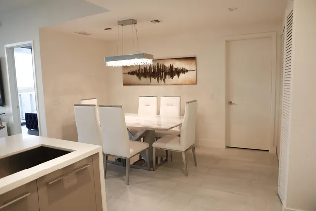 a dining room with a table and chairs