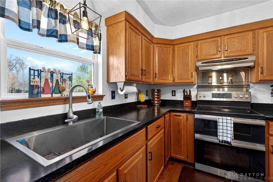 6560 Snyder Road Fletcher, OH 45326 - Photo 22 of 71 This spacious kitchen offers ample cabinet storage and a practical layout for daily living.