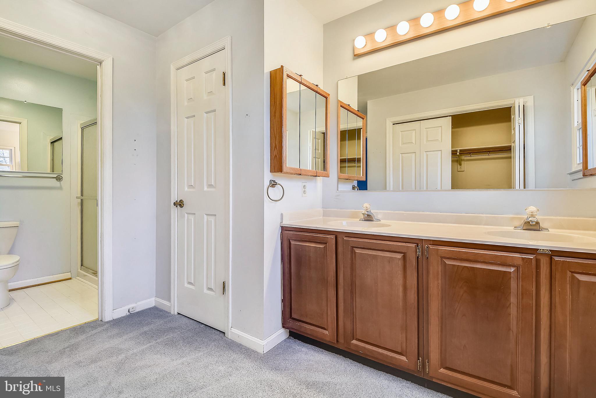 2515 Potts Point Road Huntingtown, MD 20639 - Photo 12 of 19 a spacious bathroom with a double vanity sink and a mirror