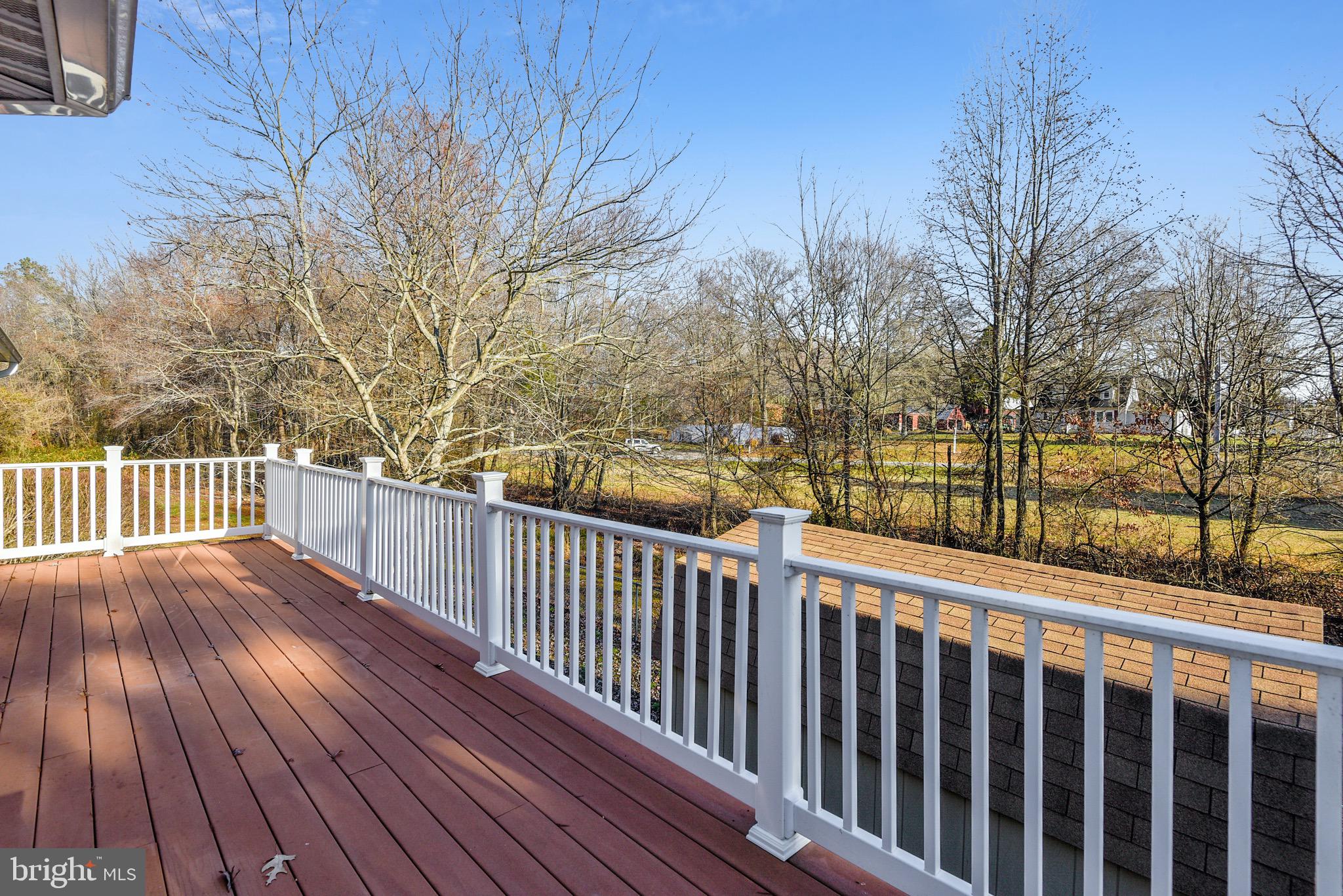 2515 Potts Point Road Huntingtown, MD 20639 - Photo 3 of 19 a view of deck with wooden floor and fence