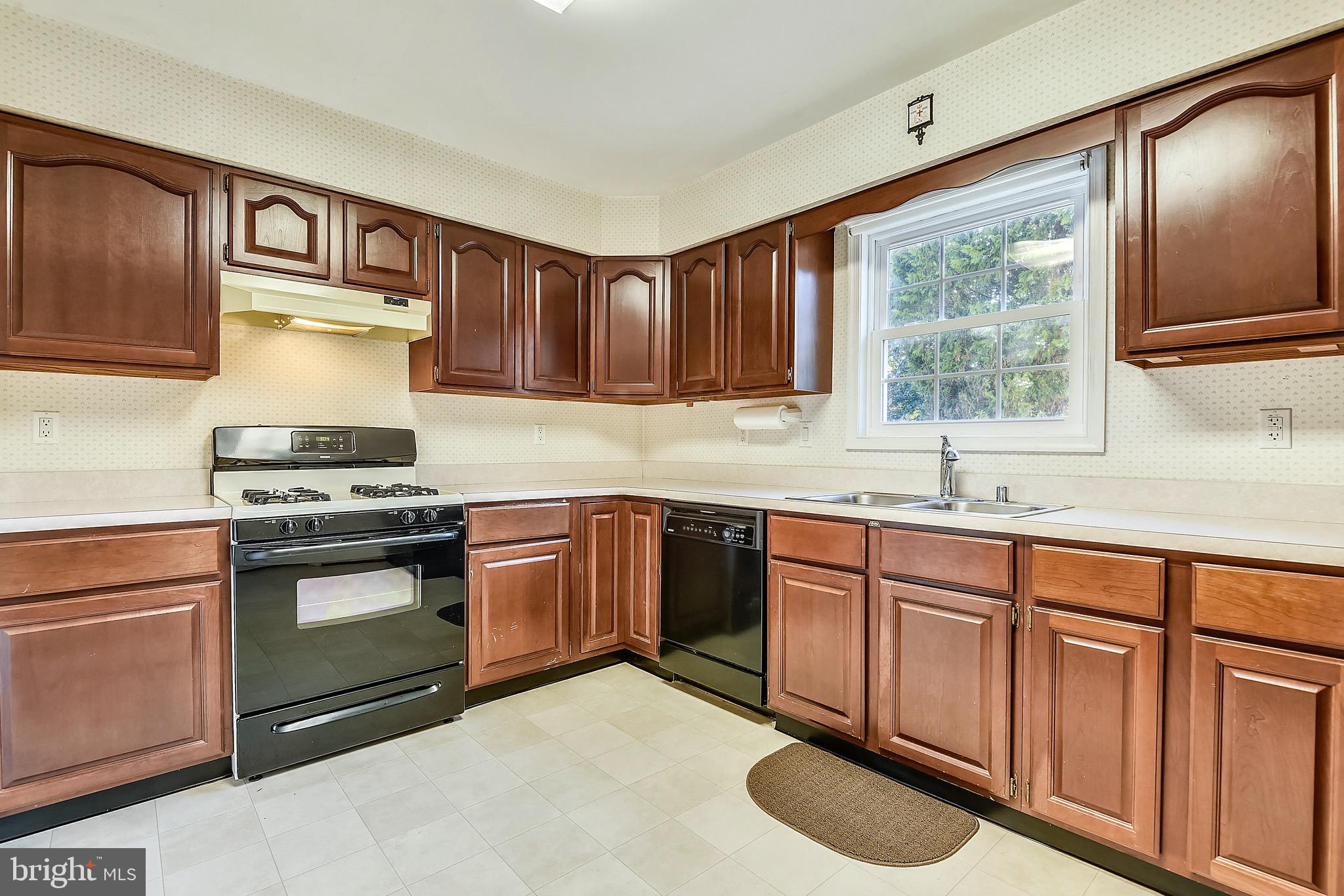 2515 Potts Point Road Huntingtown, MD 20639 - Photo 5 of 19 a kitchen with granite countertop a sink stainless steel appliances and cabinets