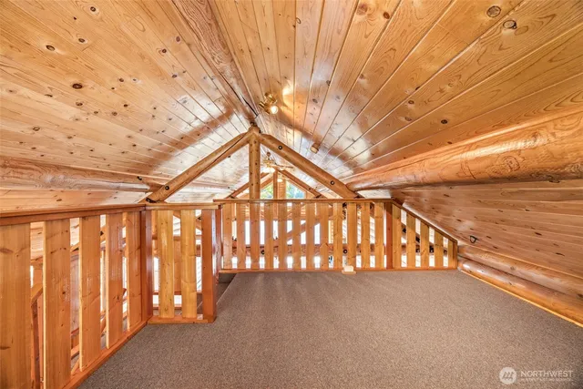 a view of empty room with wooden floor and fireplace
