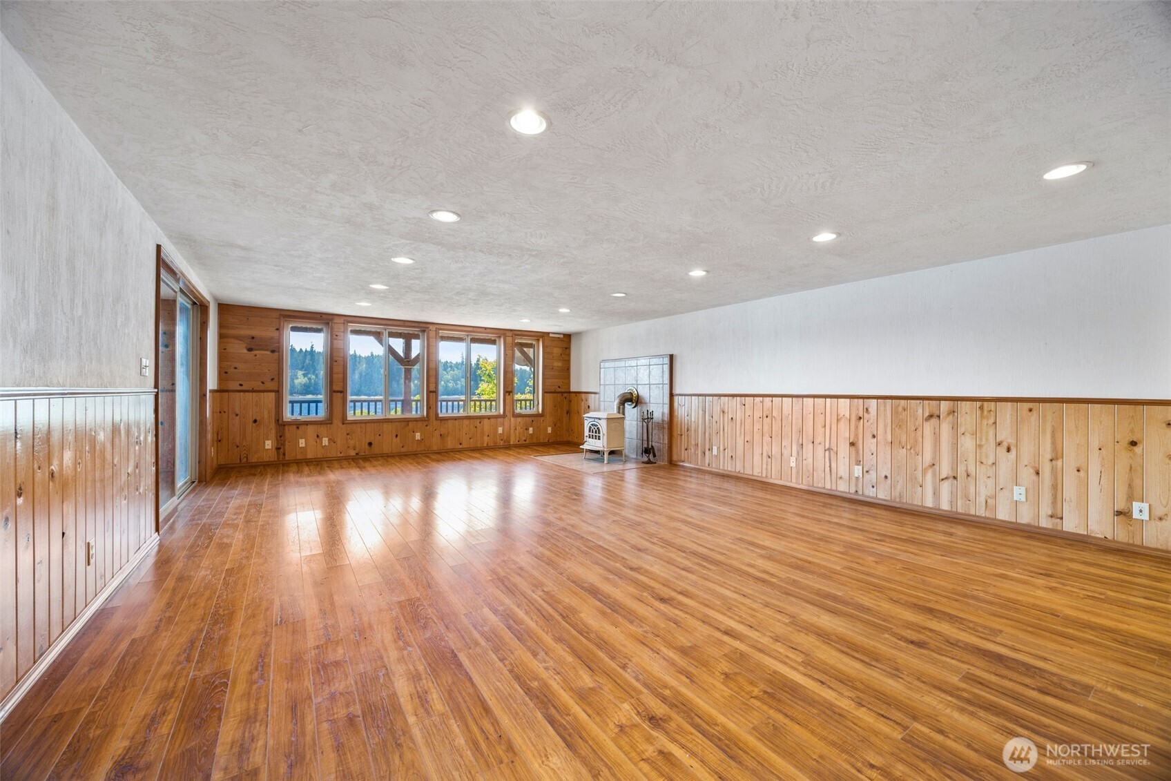1236 East Island View Road Grapeview, WA 98546 - Photo 23 of 40 a view of empty room with wooden floor and fan