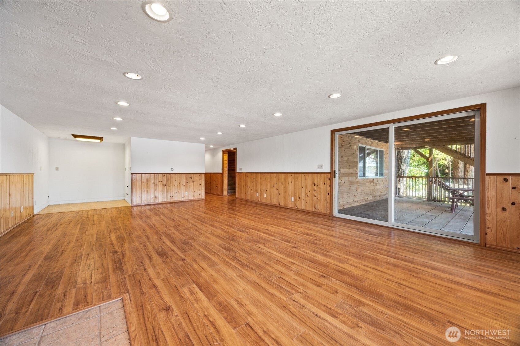 1236 East Island View Road Grapeview, WA 98546 - Photo 24 of 40 a view of empty room with wooden floor and fireplace
