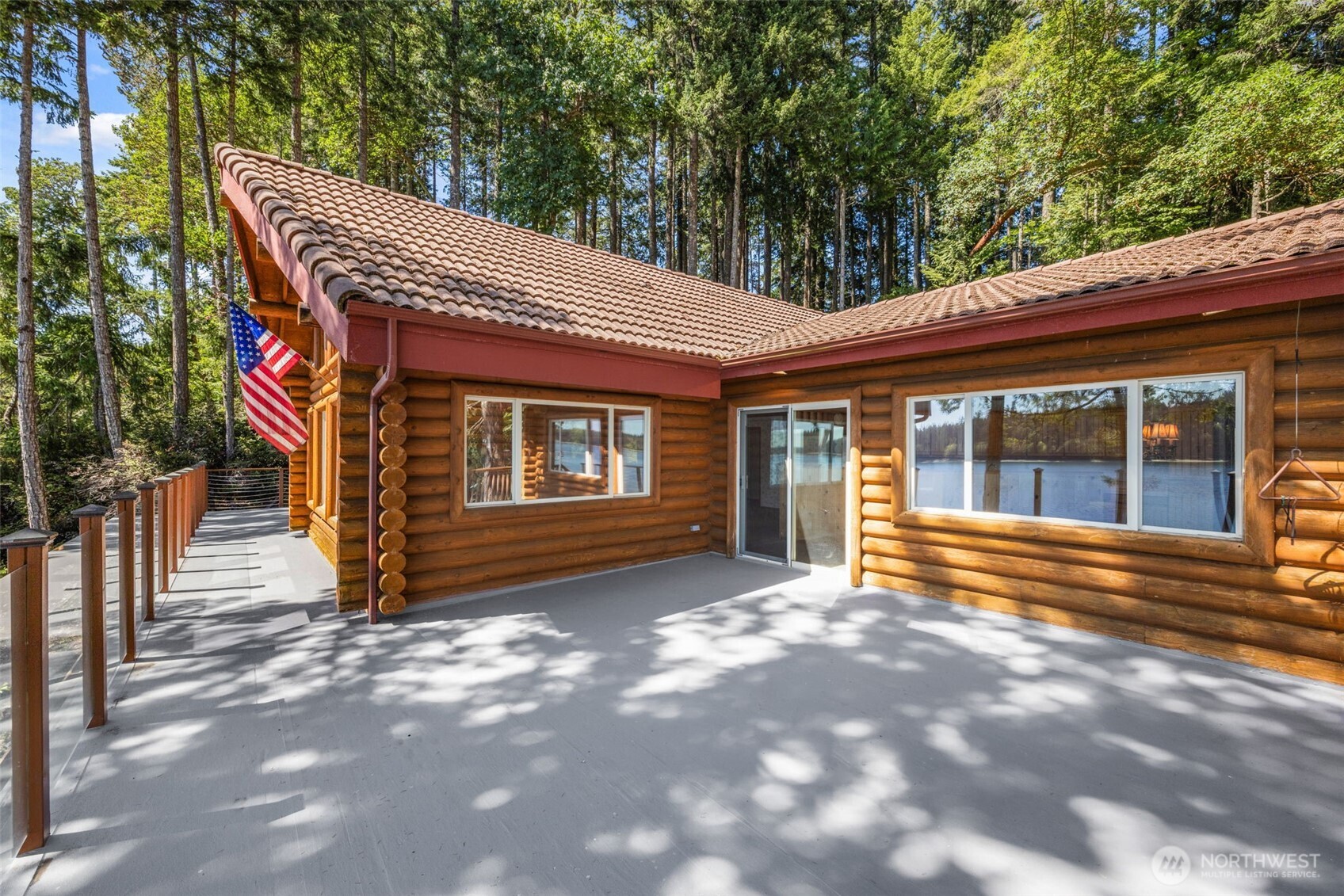 1236 East Island View Road Grapeview, WA 98546 - Photo 27 of 40 a view of a house with a large window and potted plants