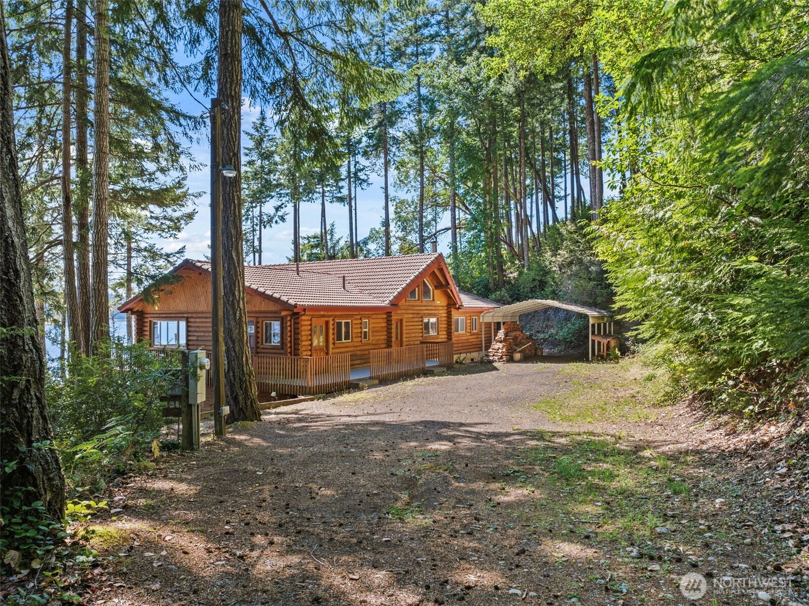 1236 East Island View Road Grapeview, WA 98546 - Photo 5 of 40 front view of a house with a trees