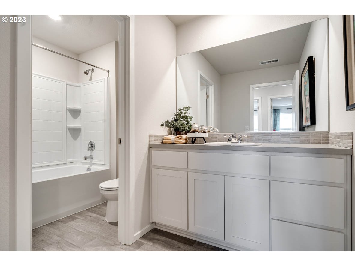 2716 Fenya Street Springfield, OR 97477 - Photo 17 of 19 a bathroom with a sink a toilet and a large mirror