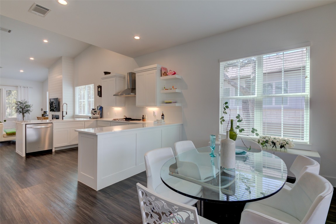 170 Bunker Rnch Boulevard, Unit 64 Dripping Springs, TX 78620 - Photo 12 of 37 a kitchen with kitchen island stainless steel appliances a sink and a stove
