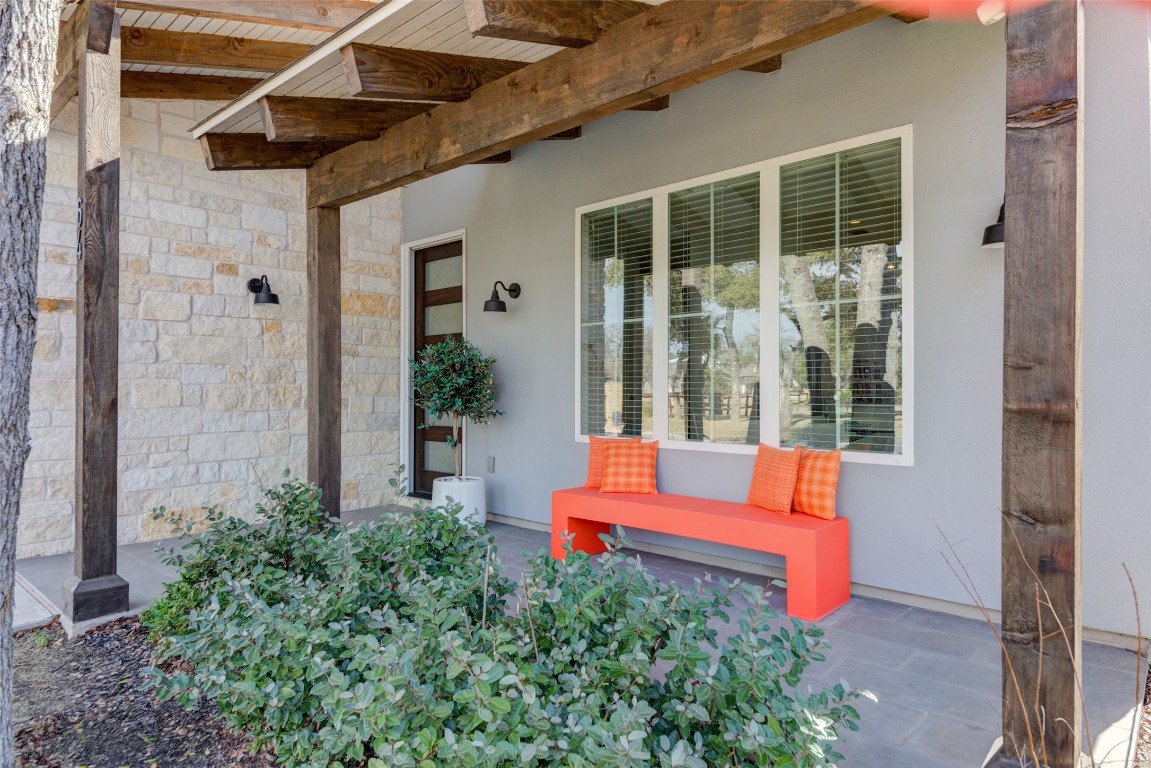 170 Bunker Rnch Boulevard, Unit 64 Dripping Springs, TX 78620 - Photo 8 of 37 a backyard of a house with outdoor seating and wooden fence
