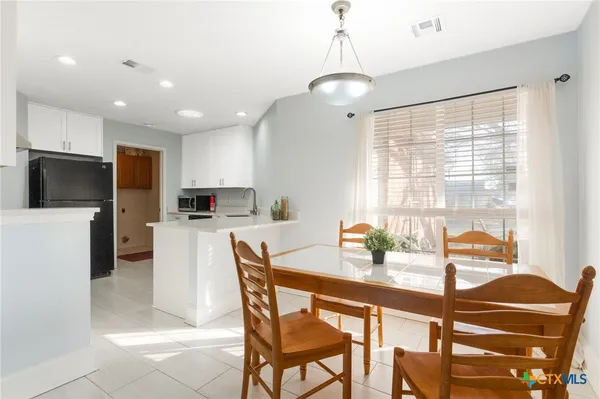 a dining room with furniture and window