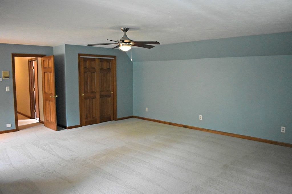 37 Throne Hill Road Groton, MA 01450 - Photo 28 of 30 an empty room with closet and a chandelier fan