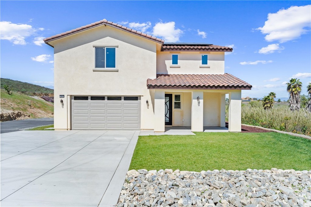 a front view of a house with a yard and garage