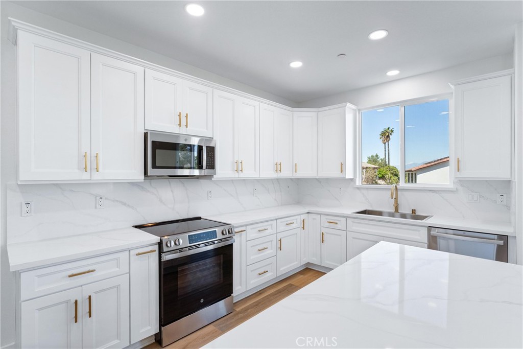 1981 Lyon Avenue Riverside, CA 92503 - Photo 11 of 58 a kitchen with stainless steel appliances white cabinets and a sink