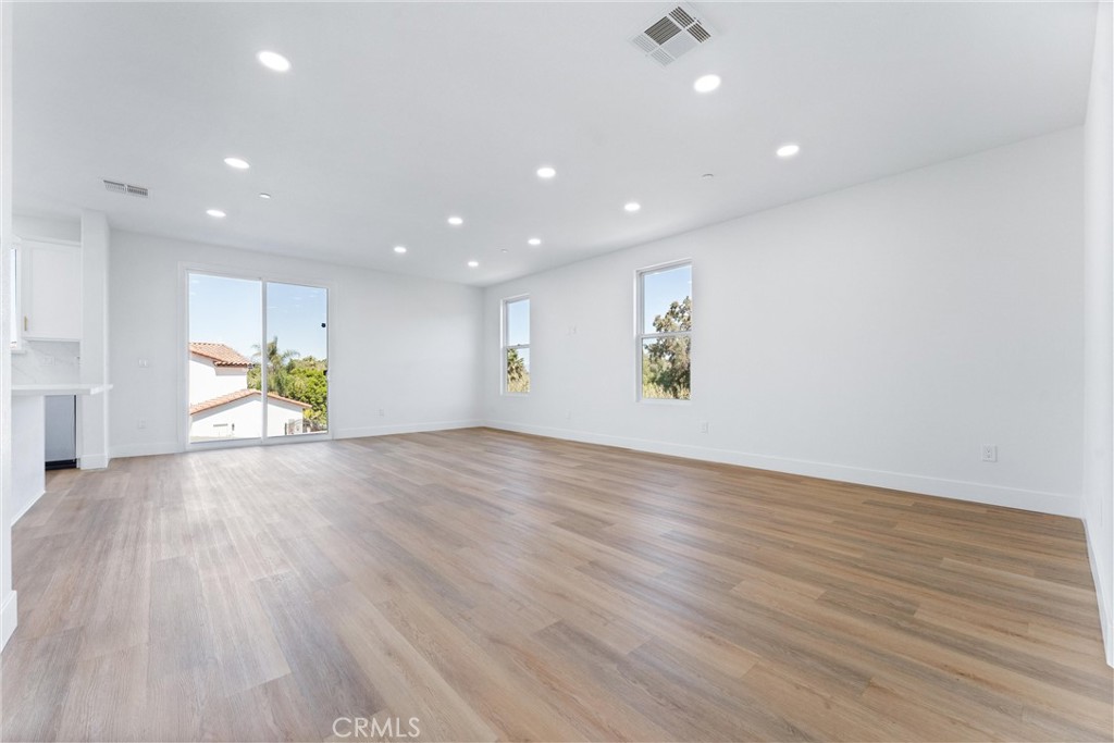 1981 Lyon Avenue Riverside, CA 92503 - Photo 12 of 58 a view of empty room with wooden floor and window