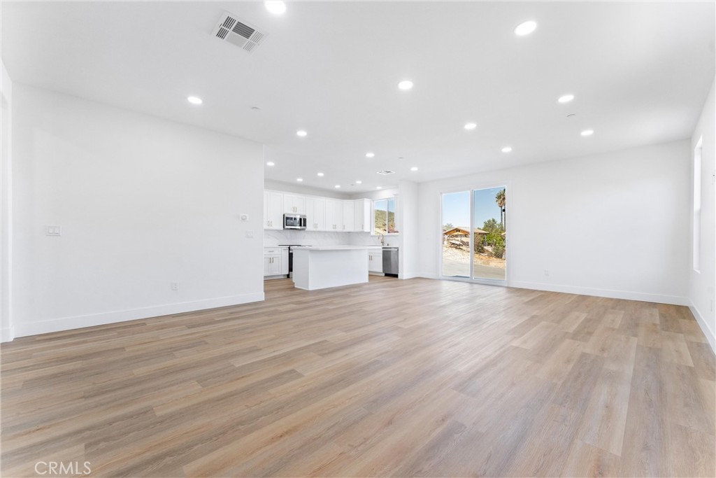 1981 Lyon Avenue Riverside, CA 92503 - Photo 15 of 58 an empty room with wooden floor and windows