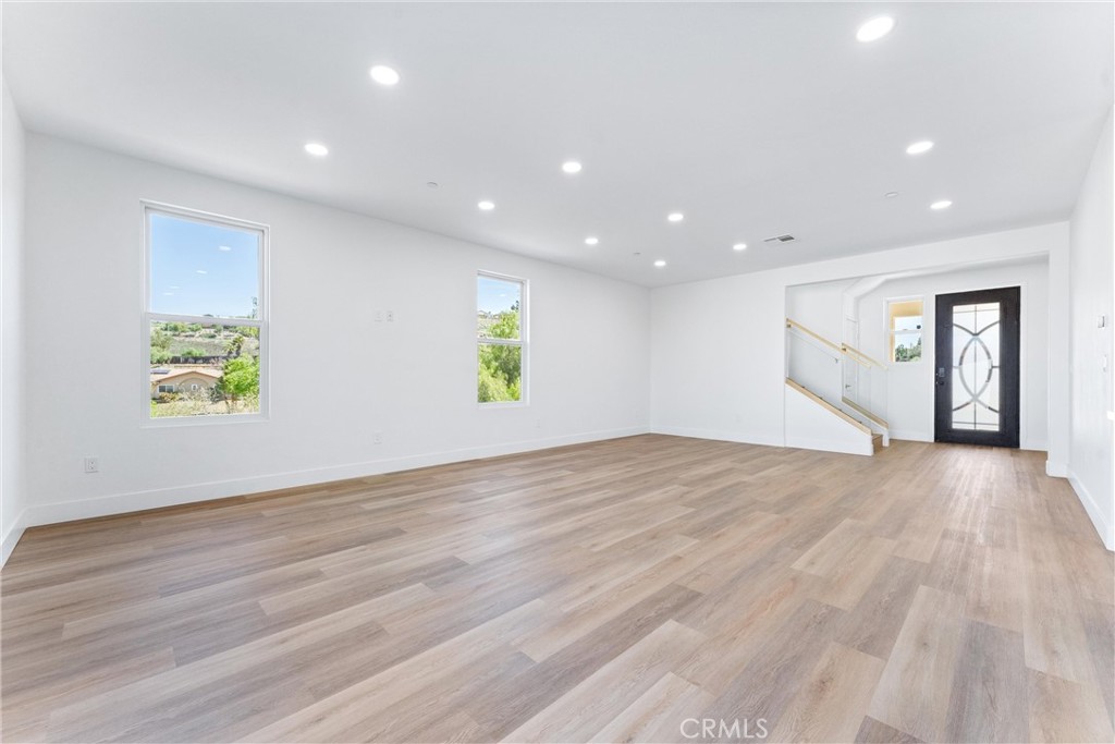 1981 Lyon Avenue Riverside, CA 92503 - Photo 18 of 58 a view of an empty room with window and wooden floor