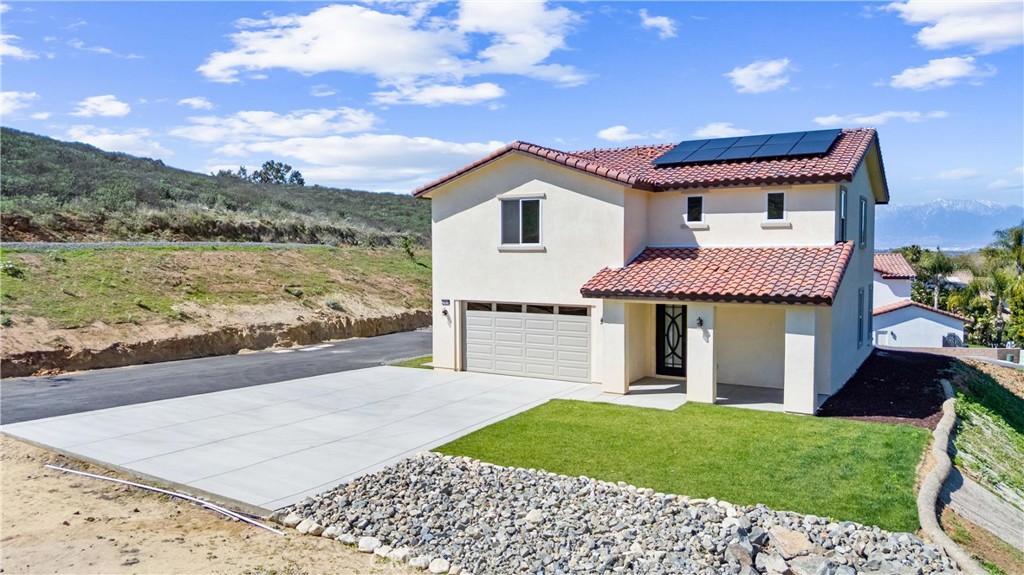 1981 Lyon Avenue Riverside, CA 92503 - Photo 2 of 58 a front view of a house with a garden and yard