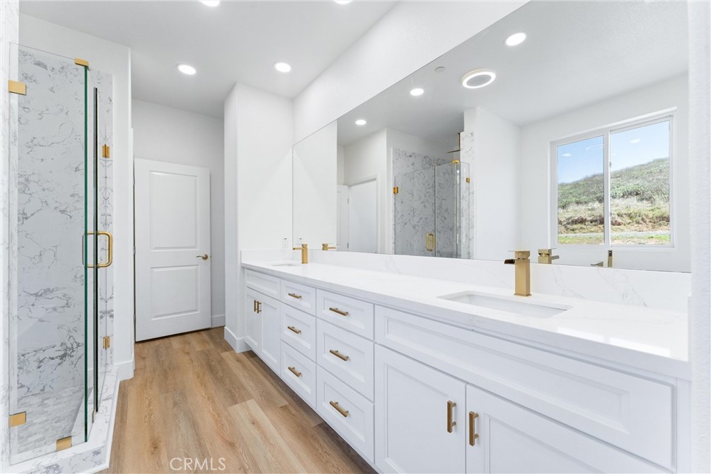 1981 Lyon Avenue Riverside, CA 92503 - Photo 23 of 58 a bathroom with a double vanity sink a mirror and a shower