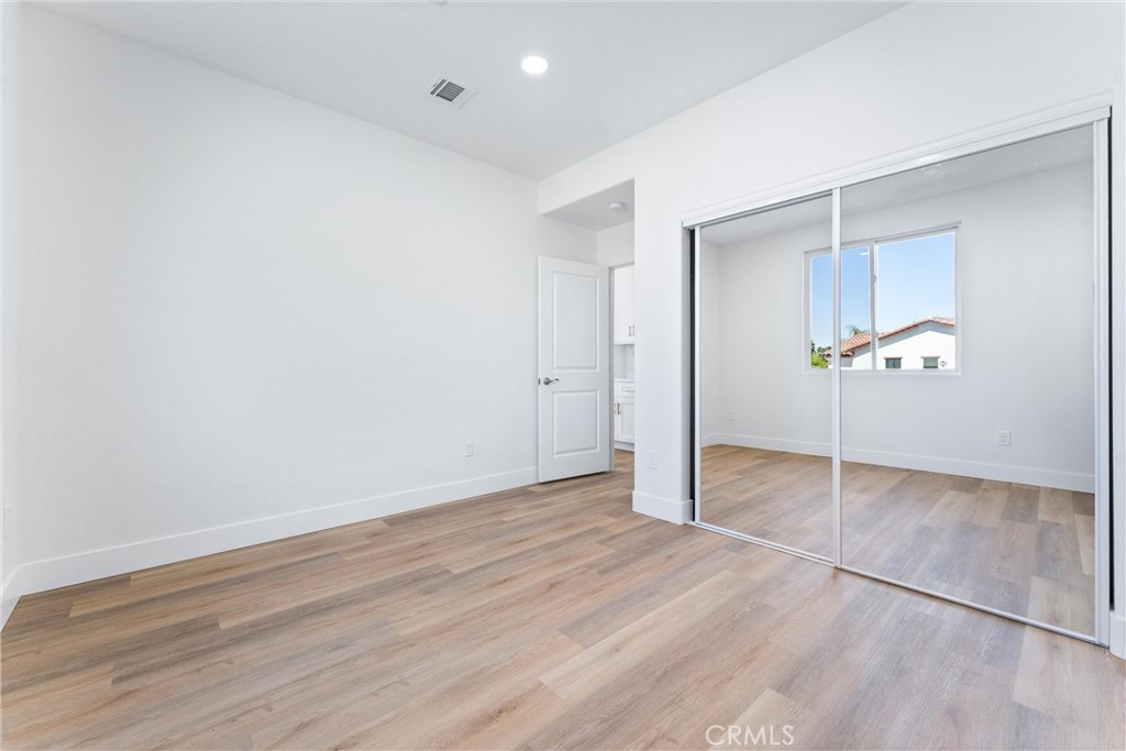 1981 Lyon Avenue Riverside, CA 92503 - Photo 28 of 58 an empty room with wooden floor and cabinet