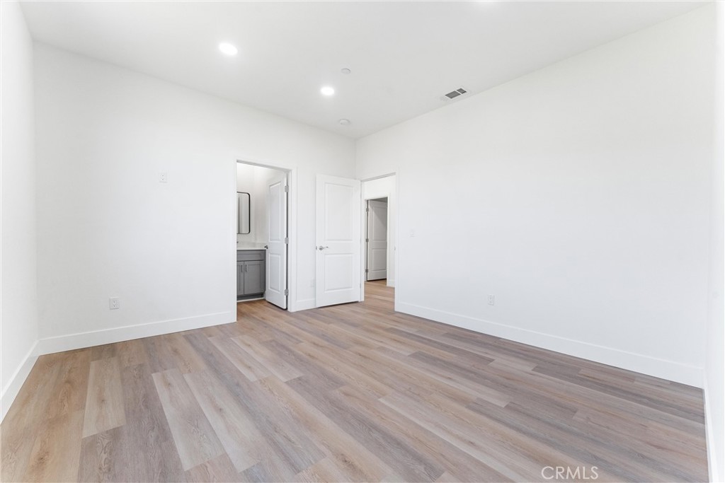 1981 Lyon Avenue Riverside, CA 92503 - Photo 29 of 58 a view of an empty room with wooden floor and a window