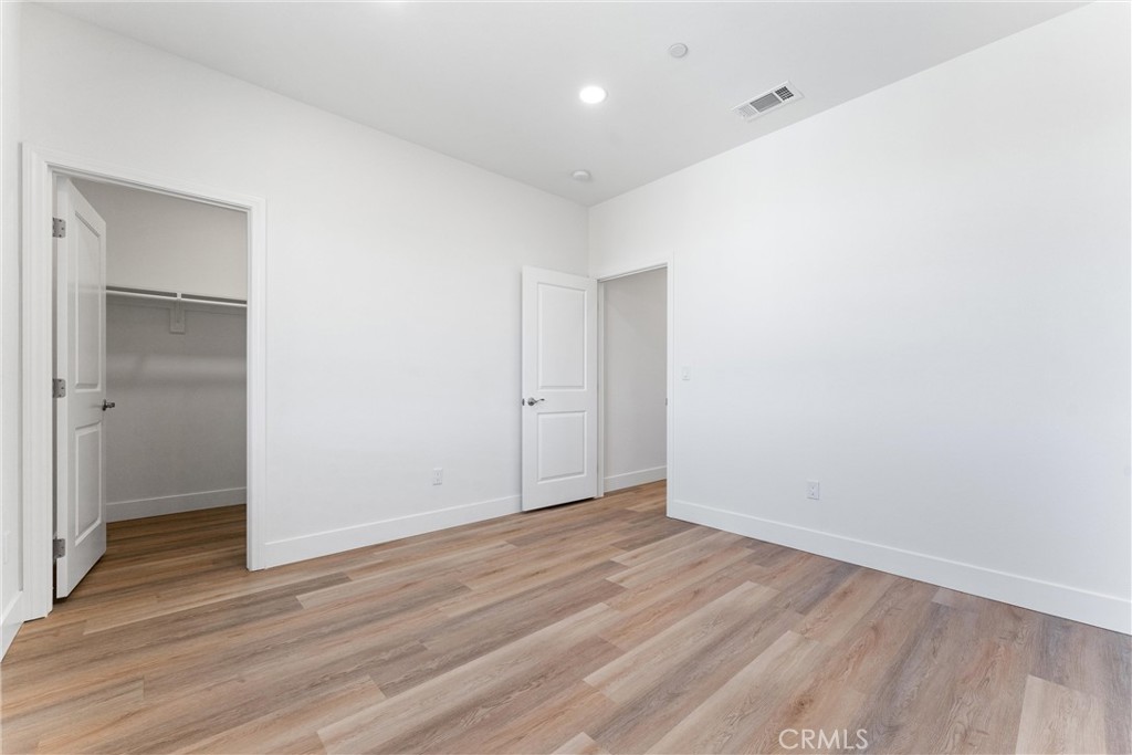 1981 Lyon Avenue Riverside, CA 92503 - Photo 32 of 58 a view of an empty room with wooden floor