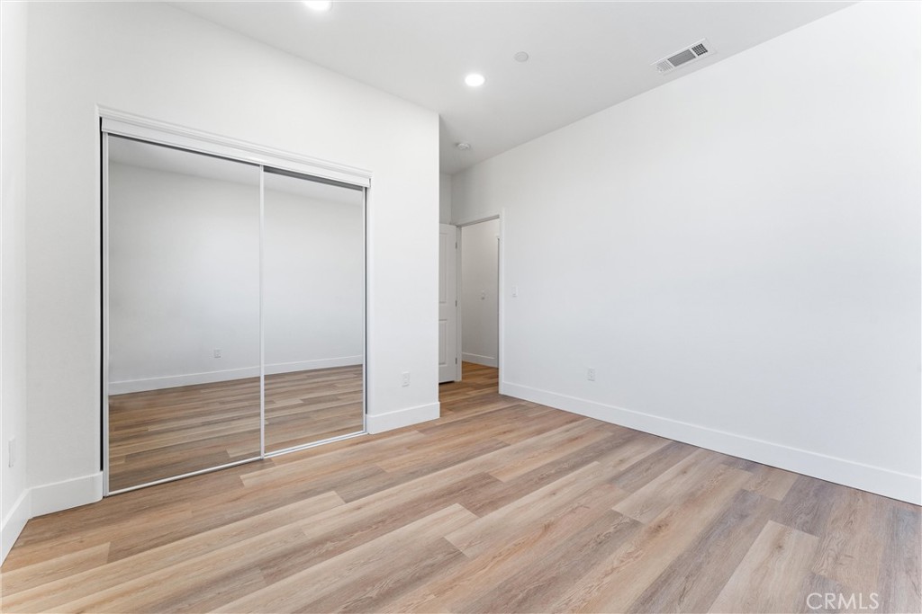 1981 Lyon Avenue Riverside, CA 92503 - Photo 33 of 58 a view of an empty room with wooden floor and a window