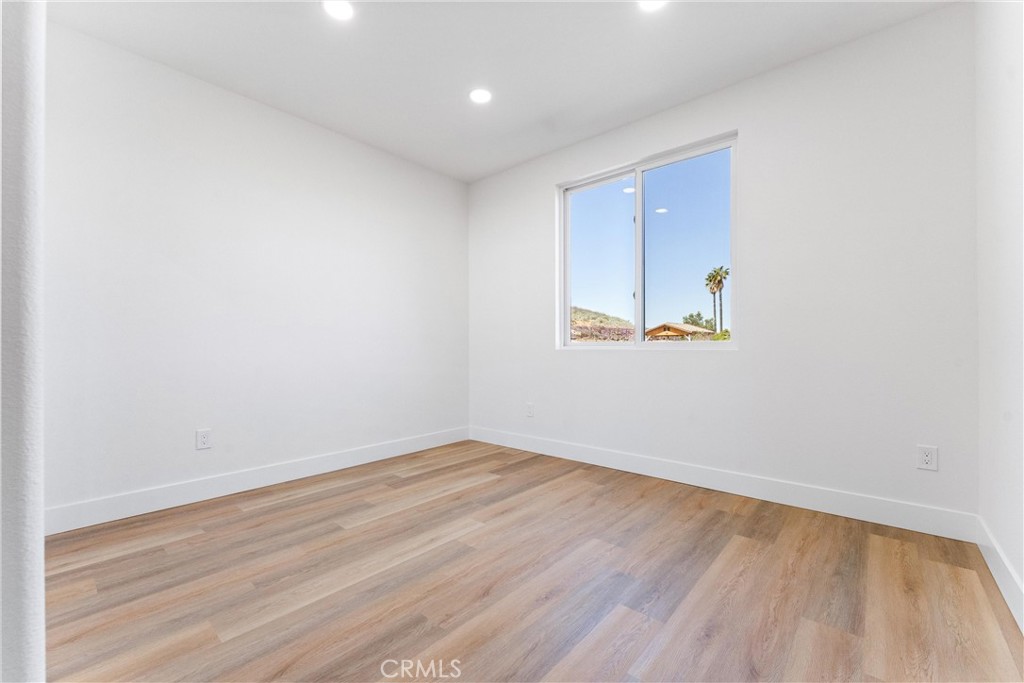 1981 Lyon Avenue Riverside, CA 92503 - Photo 36 of 58 an empty room with wooden floor and windows