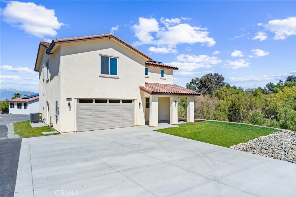 1981 Lyon Avenue Riverside, CA 92503 - Photo 40 of 58 a front view of a house with a yard and garage