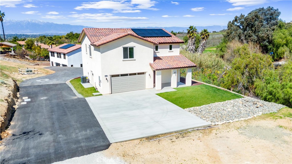 1981 Lyon Avenue Riverside, CA 92503 - Photo 4 of 58 a view of a white house with a yard and potted plants