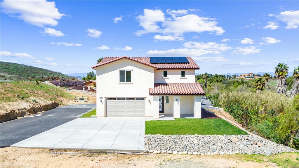 1981 Lyon Avenue Riverside, CA 92503 - Photo 47 of 58 a front view of a house with a yard and garage