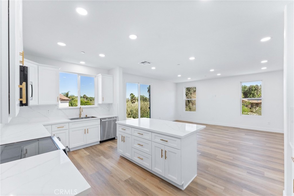 1981 Lyon Avenue Riverside, CA 92503 - Photo 9 of 58 a large white kitchen with granite countertop a large counter top and stainless steel appliances