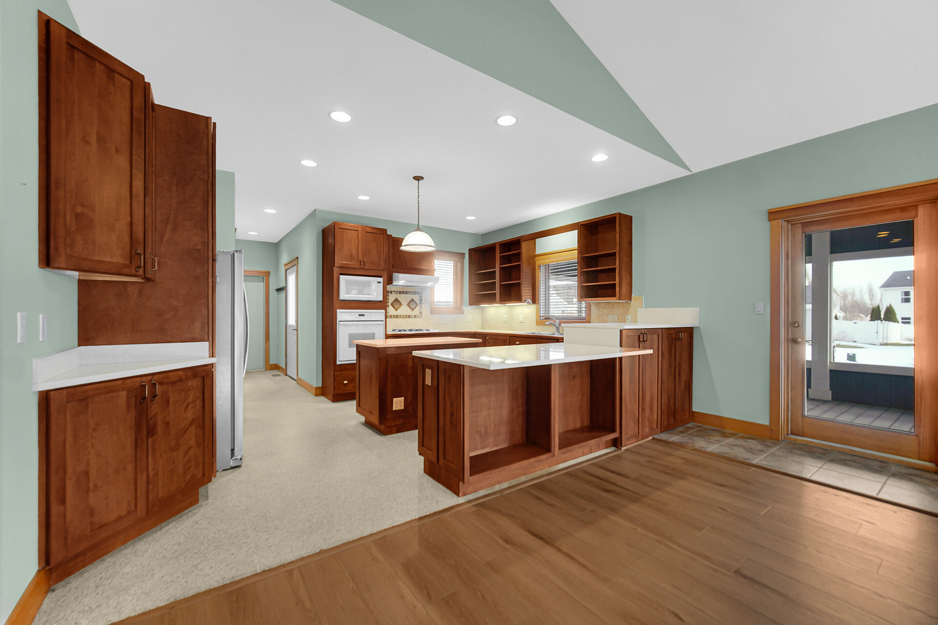 2425 Dickinson Road Chesterton, IN 46304 - Photo 11 of 41 a large kitchen with stainless steel appliances kitchen island granite countertop a stove a refrigerator and a sink with large countertops