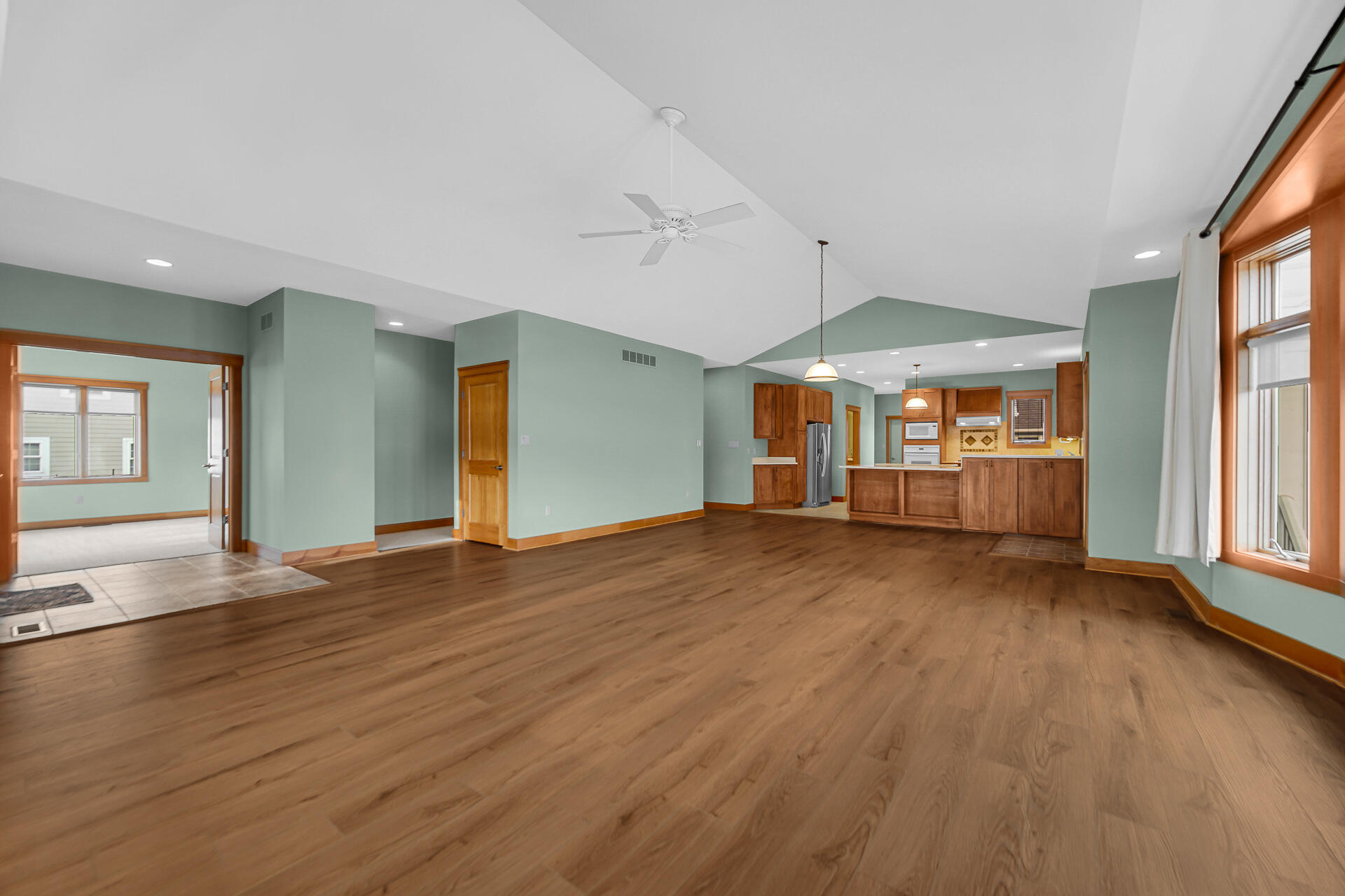 2425 Dickinson Road Chesterton, IN 46304 - Photo 7 of 41 an empty room with wooden floor windows and chandelier