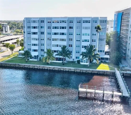 a aerial view of a house with a lake and a building