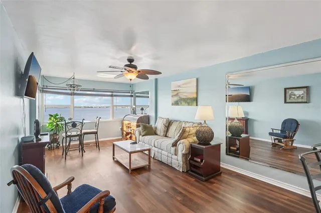 a living room with furniture and wooden floor