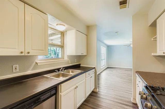 a kitchen with a sink stove and cabinets