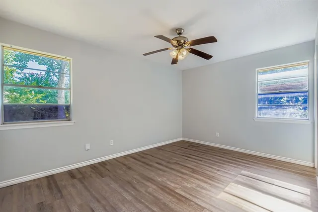 a view of a room with wooden floor and natural light