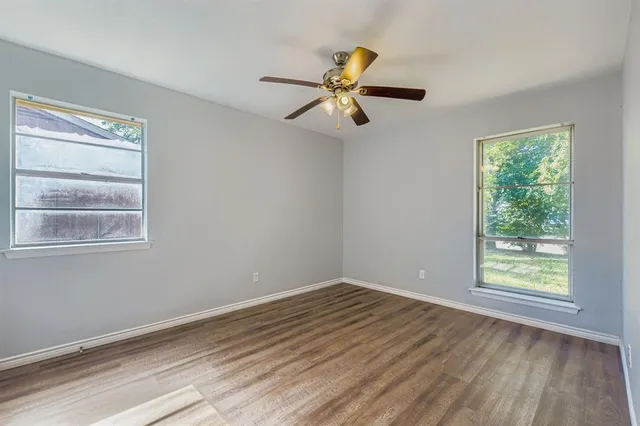 a view of a room with wooden floor and windows