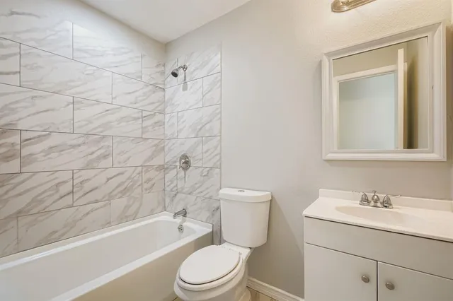a bathroom with a sink toilet and bathtub